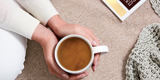 moccona hands holding cup of coffee banner