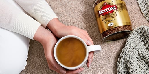 moccona hands holding cup of coffee